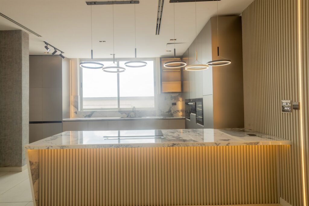 Brum Height 6: Breakfast island facing the kitchen worktop and window